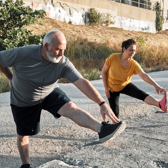 Two people stretching outside