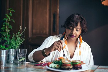 person eating a healthy meal at home to reduce body fat