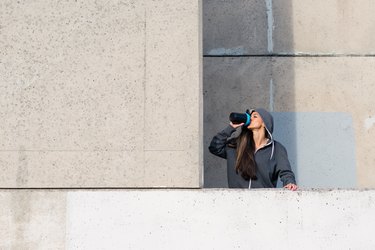 woman drinking protein shake with muscle milk after workout