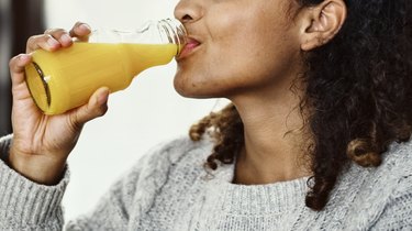 Woman drinking fresh orange juice